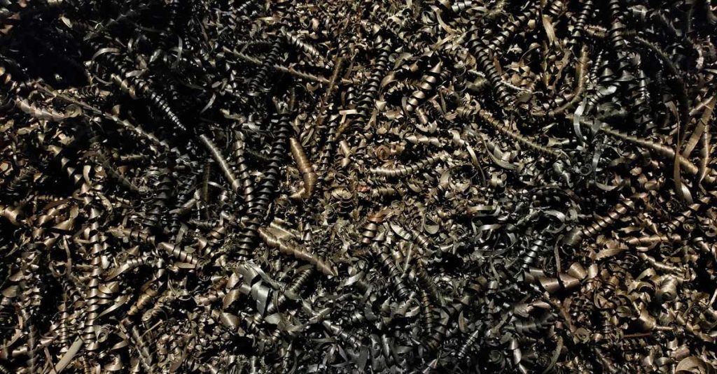Detailed close-up of a heap of twisted metal shavings, showcasing a complex texture.