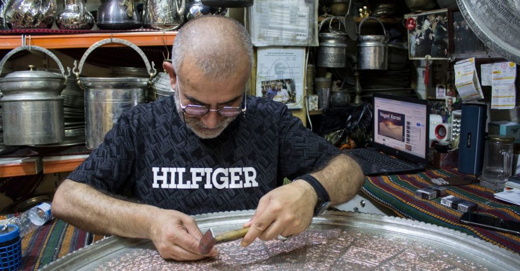 Coppersmith hammering intricate designs into metal, Gaziantep. Authentic Turkish craftsmanship.