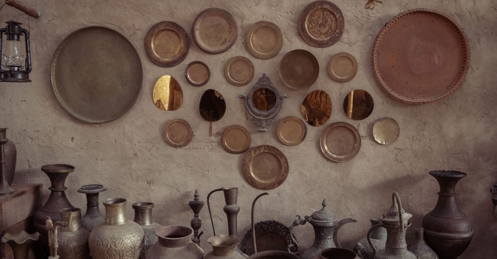 A rustic wall adorned with vintage metal plates and pottery, creating a nostalgic ambiance.