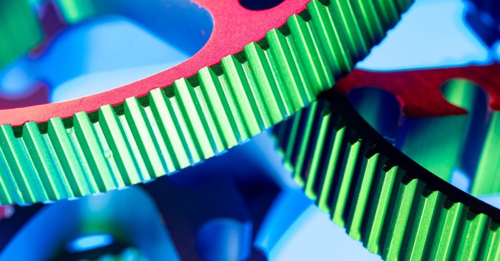 Close-up of vibrant metal gears showcasing precision engineering with a modern abstract twist.