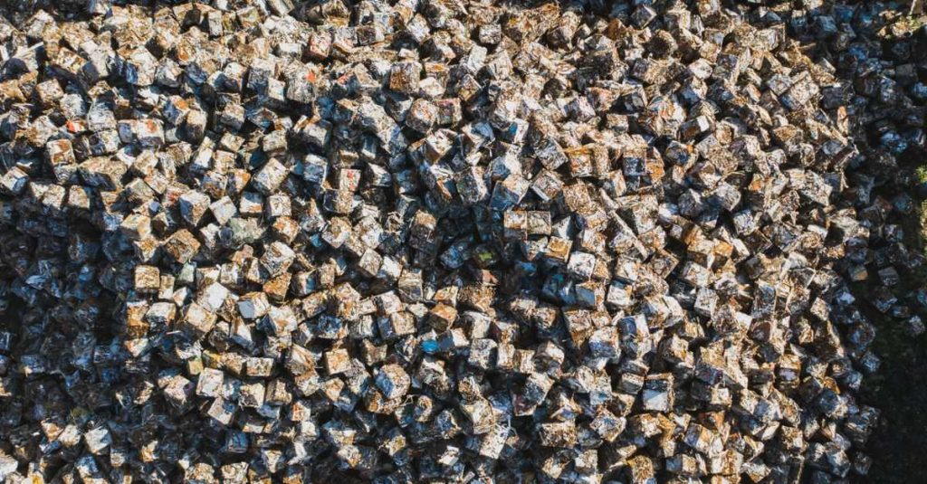 Aerial perspective of densely packed metal scrap cubes in an industrial setting, highlighting recycling.