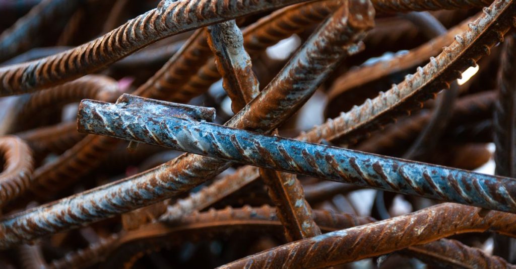 A detailed close-up of twisted, rusty iron rebar. Perfect for construction and industrial themes.