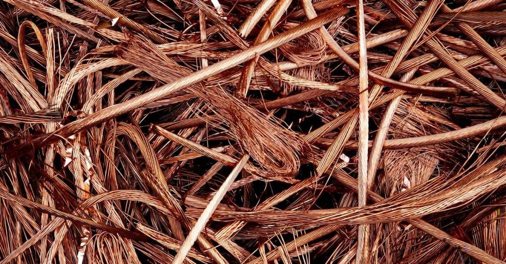 Close-up view of intertwined copper wires ready for recycling, emphasizing industrial reuse.