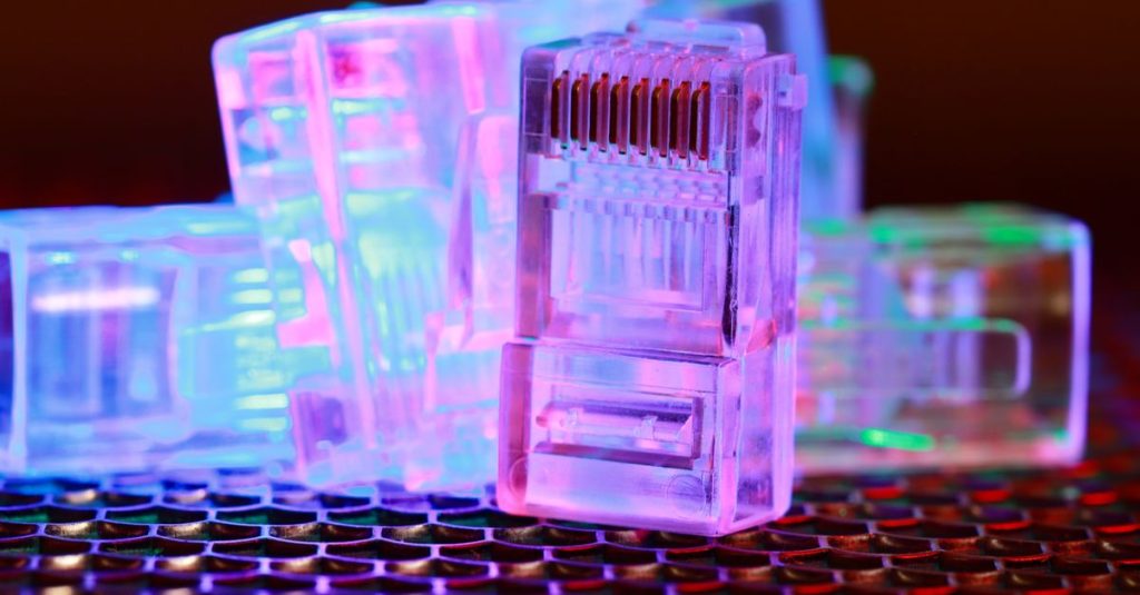 Vibrant close-up of network cable connectors with colorful lighting.
