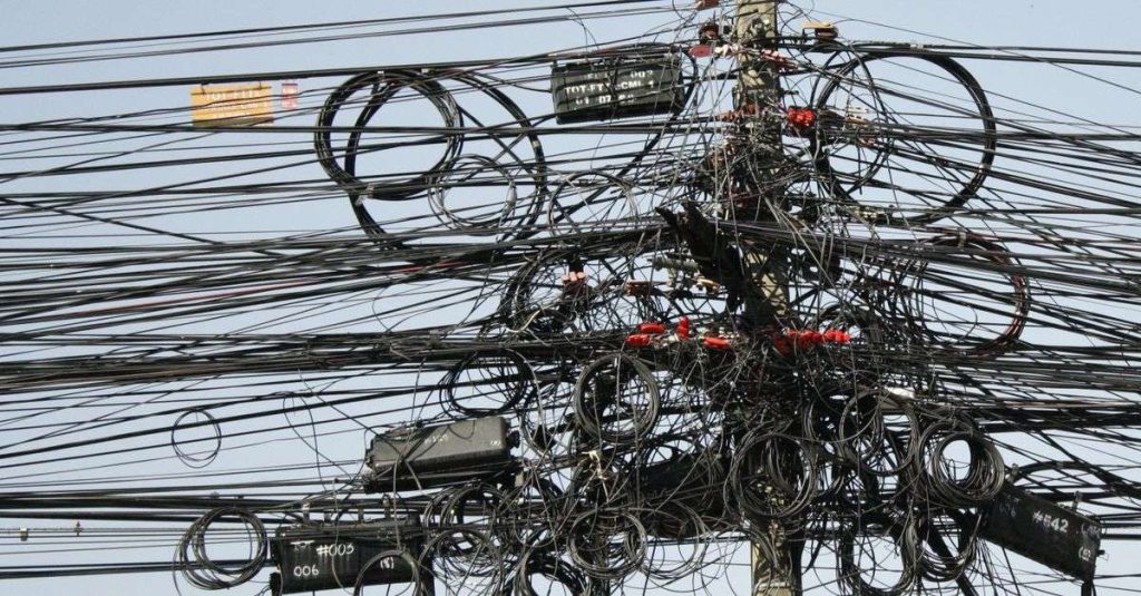 Complex network of tangled power lines and cables in Chiang Mai, Thailand.