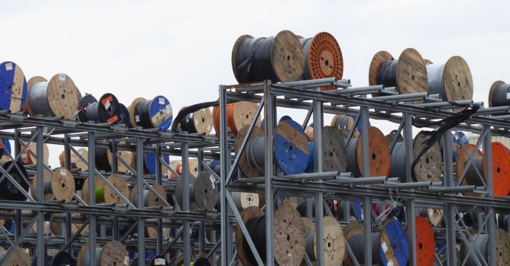 Colorful industrial cable reels stacked outdoors in Alphen aan den Rijn.