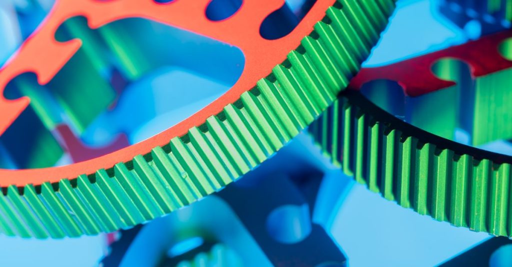 Vibrant macro shot of colorful interlocking gears showcasing engineering precision and modern technology.