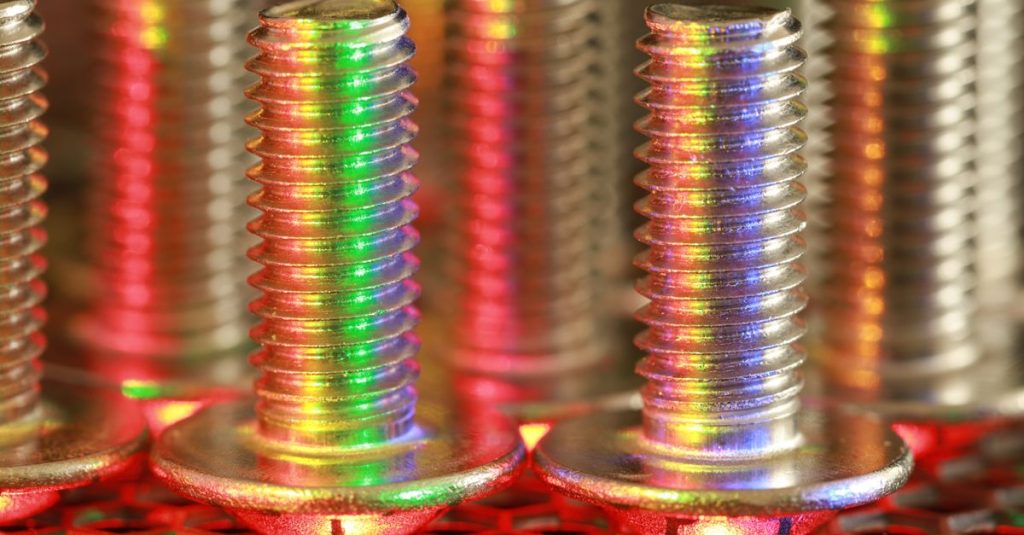 Vibrant gradient colors reflecting on metallic screws, showcasing industrial elegance.