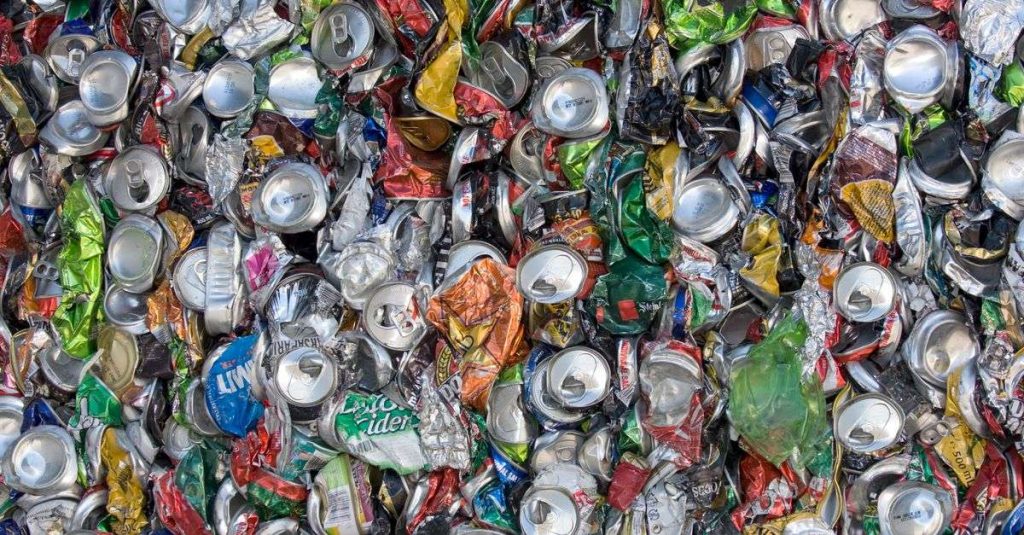 Colorful crushed aluminum cans emphasizing sustainability and recycling.
