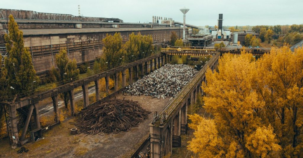 Aerial shot of old ironworks surrounded by autumn trees in Warszawa, Poland.