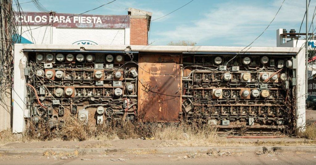 Abandoned rusty electrical panel with wires in Mexico street.