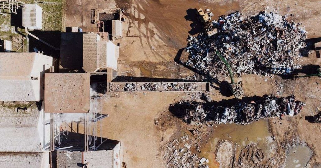 Aerial shot of a recycling yard with piles of scrap metal and waste in Chattanooga.