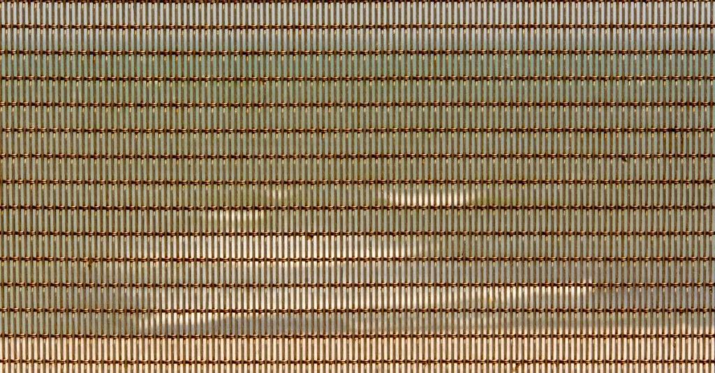 Close-up view of a metallic wire mesh showcasing geometric patterns and textures.