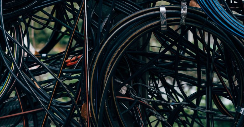 Close-up view of a complex tangle of electrical wires outdoors.