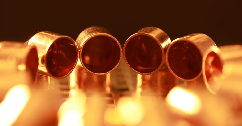 Macro shot of brass tubes with warm, glowing lighting, showcasing a serene and vintage ambiance.