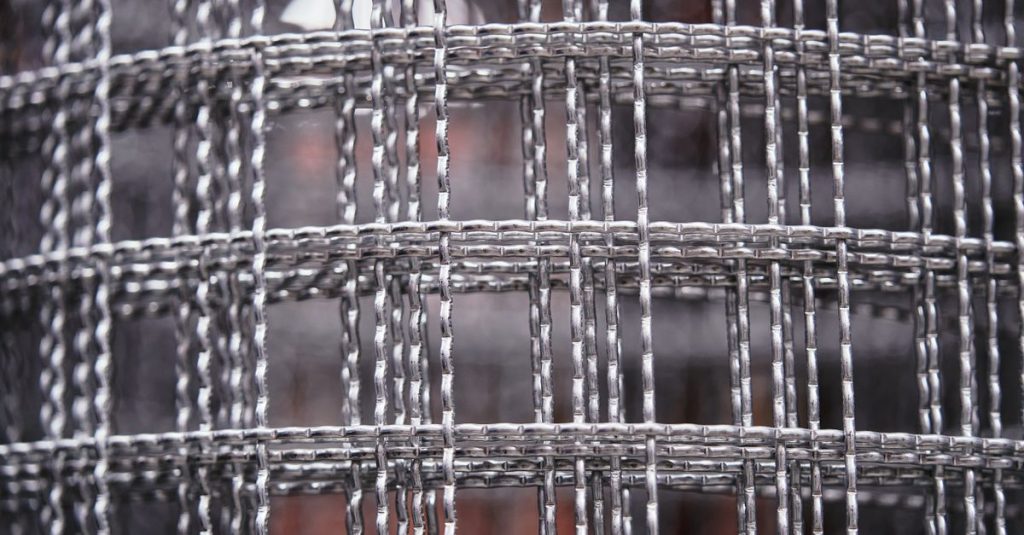 Detailed close-up of a metal wire mesh with intricate patterns and textures, ideal for industrial design concepts.