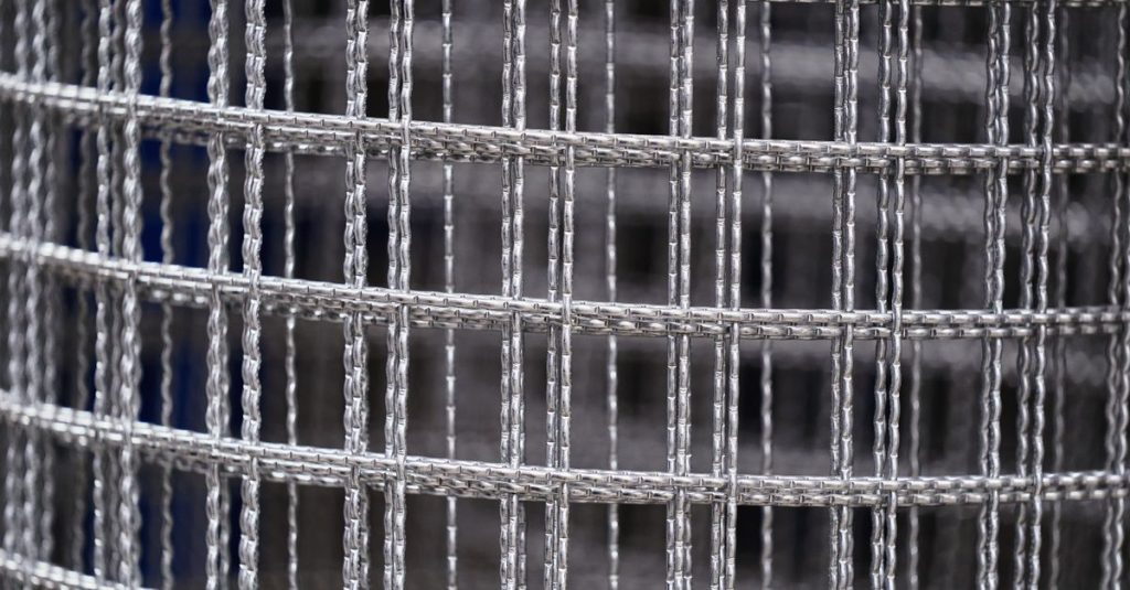 Detailed view of a tightly wound steel wire mesh roll, showcasing industrial craftsmanship.