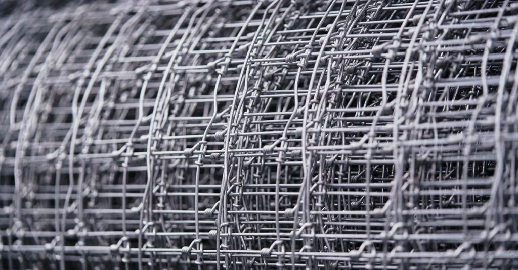 Detailed view of a rolled metal wire mesh, highlighting intricate patterns and textures.