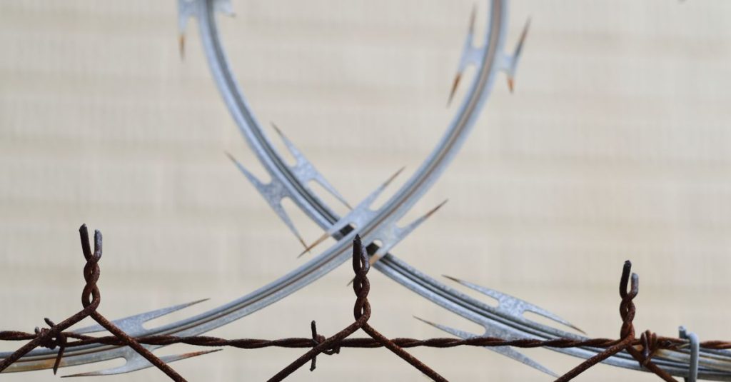 Detailed view of a rusted barbed wire fence for security and protection outdoors.