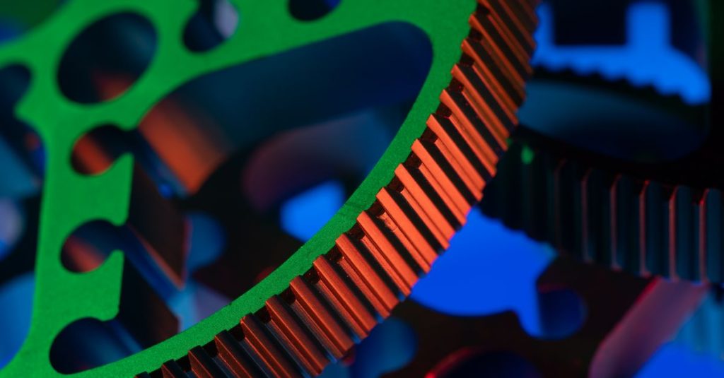 Close-up macro image of vibrant colored gears showcasing precision engineering and industrial mechanics.