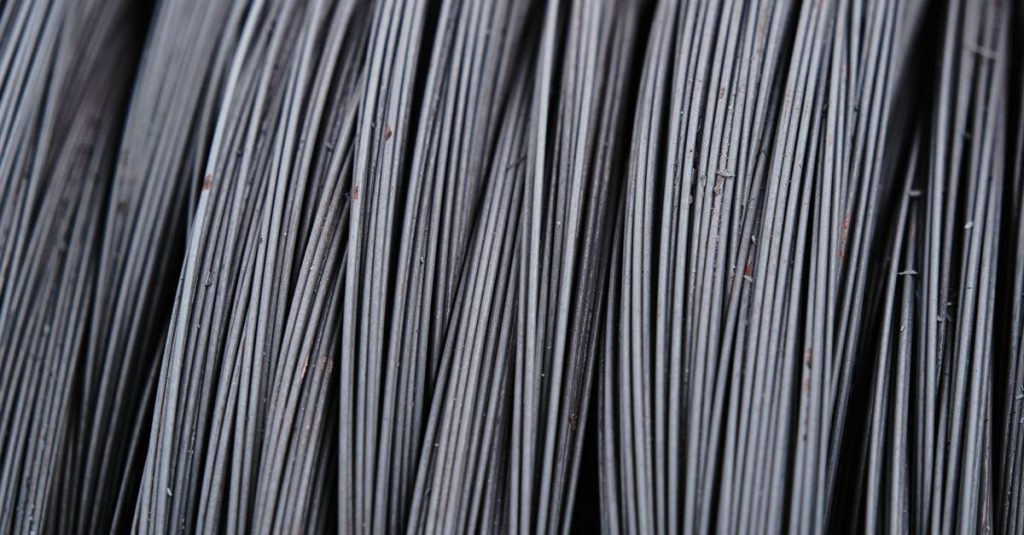 Detailed macro shot of intertwined metal wires, showcasing industrial texture.