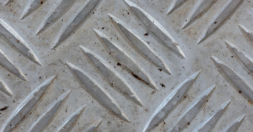 High-resolution image of a textured metal surface in Minas Gerais, Brazil, showing intricate patterns.