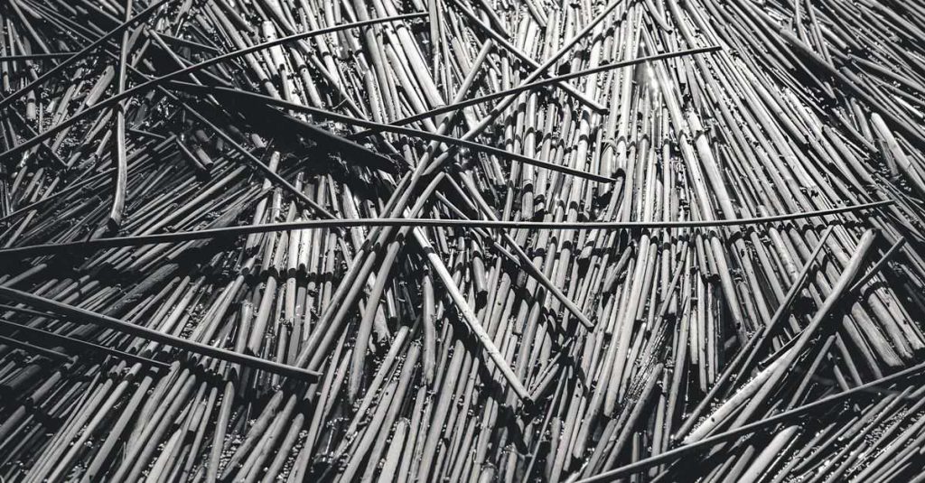 Textured black and white close-up of bamboo sticks arranged in abstract pattern.
