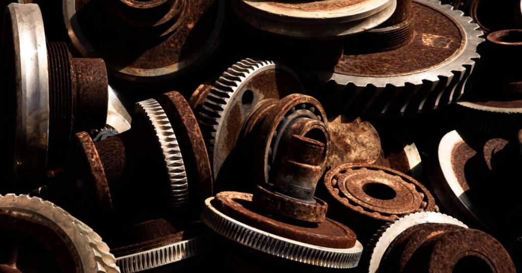 Detailed close-up of rusty industrial gears showcasing texture and metal wear.