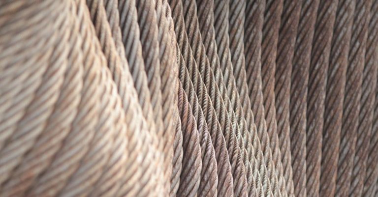 A detailed view of coiled steel cables showcasing a textured abstract pattern.