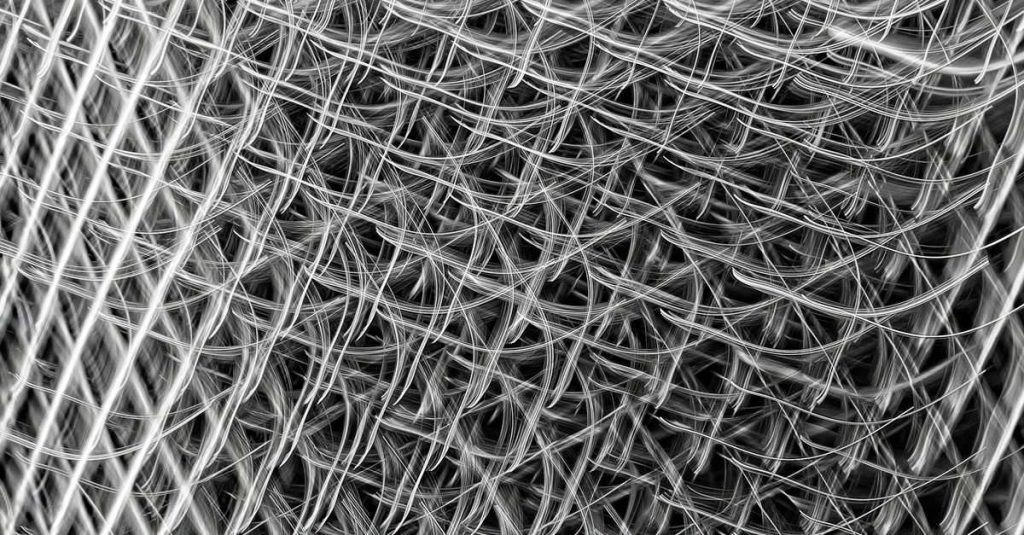 Complex lattice of interwoven metallic wires creating a modern abstract texture.