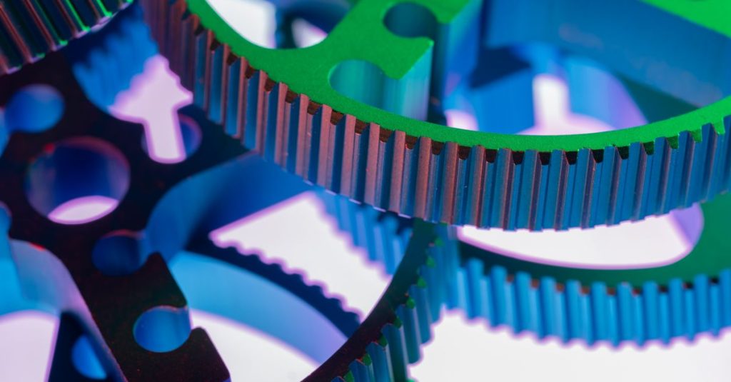 Vividly colored metal gears in a close-up shot, emphasizing industrial precision and mechanical design.