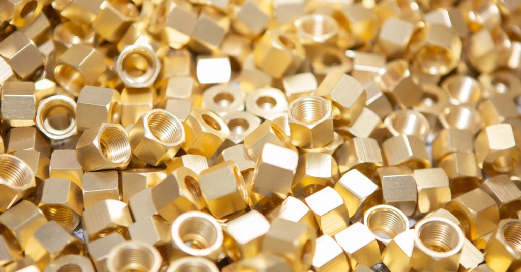 A detailed image showcasing a pile of shiny golden nuts, highlighting their metallic texture.