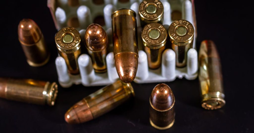 Pazar Hurdacı Detailed view of copper bullets and cartridge cases in a container against a dark background.