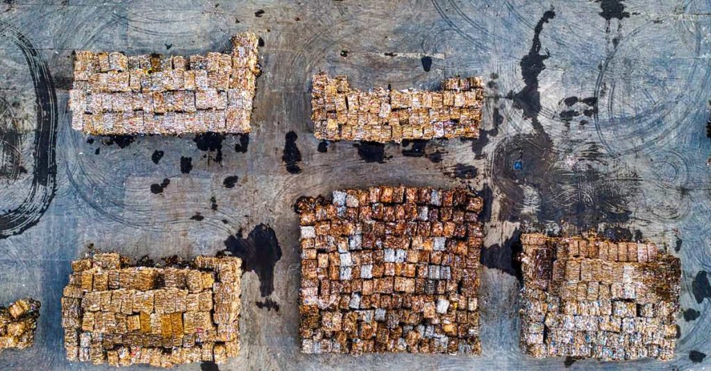 Aerial shot of organized recyclable material stacks in Serang, Indonesia, highlighting waste management efforts.
