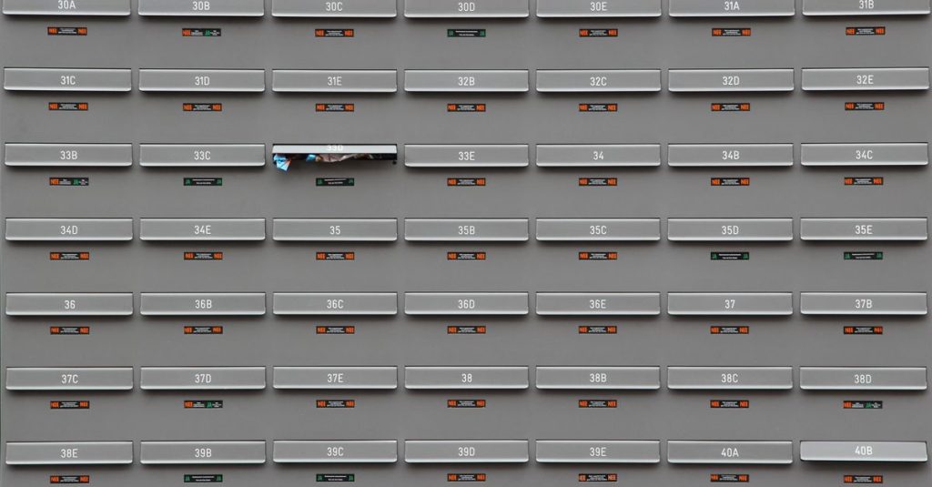 A grid of grey mailboxes with number labels showing an organized system.