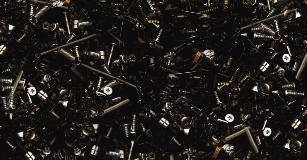 A detailed close-up view of various metal screws and bolts, showcasing industrial hardware.