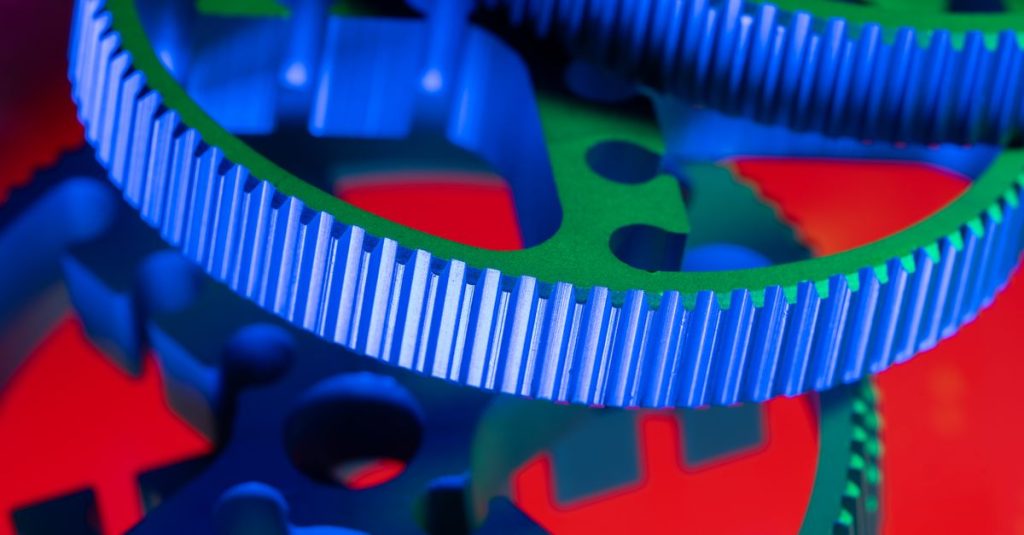 Vivid macro shot of colorful interlocking gears showcasing precision engineering.
