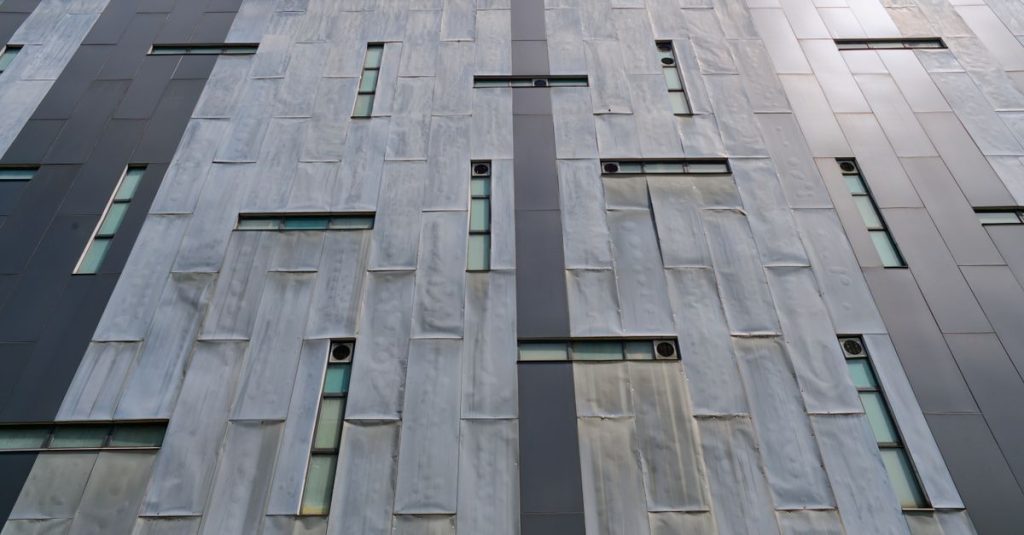 Viranşehir Hurdacı Upward view of a building facade with modern architectural design and narrow windows.