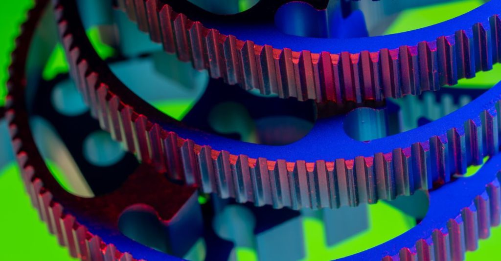 Vibrant close-up of interlocking colorful gears showcasing industrial precision and engineering.
