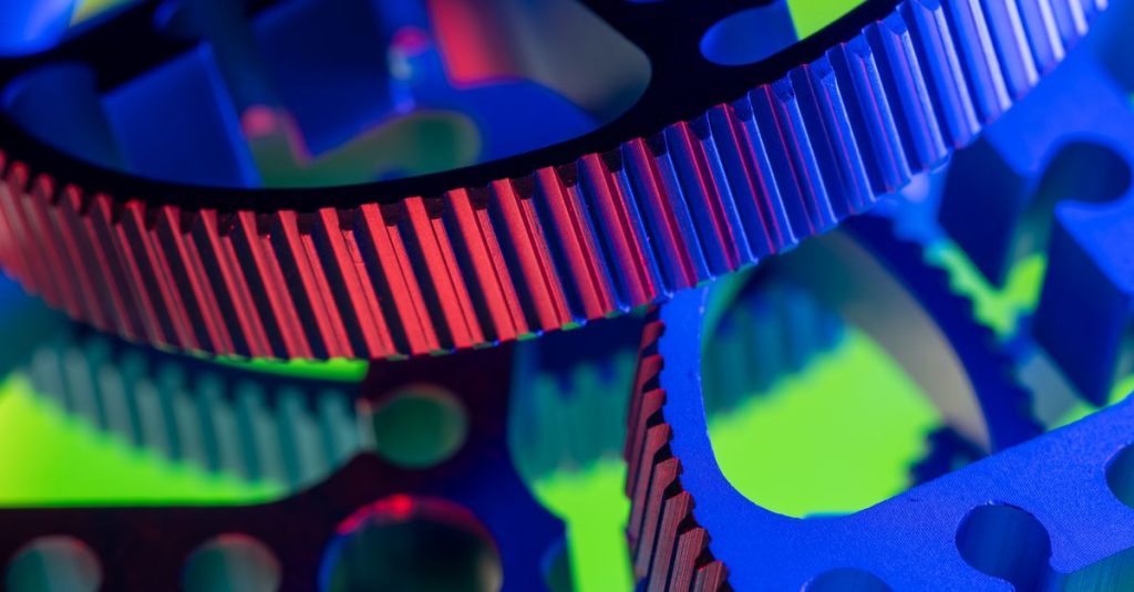 Vibrant close-up image of colorful industrial gears, showcasing precision engineering.